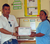 Mariyah Hanjit, one of the 18 students who passed the computer course collects her graduation certificate.