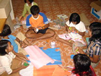 The children make use of the community center, making their recycled models each week.