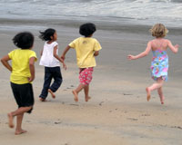 Daughter of the family, Lucy, runs into the sea with her new friends.