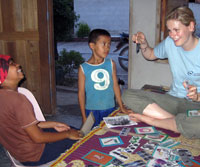 Amy helping the homestay children with their English using the homestay pack created by previous AD volunteers. 