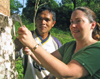 Anna learning how natural rubber is tapped from a tree with local guide, Bang Hem.