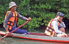 Beth on a traditional long-tail boat in the mangroves of Tung Nang Dam