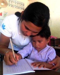 Child with teacher at Migrant Education Program for Burmese migrant children of Kuraburi, Phang Nga